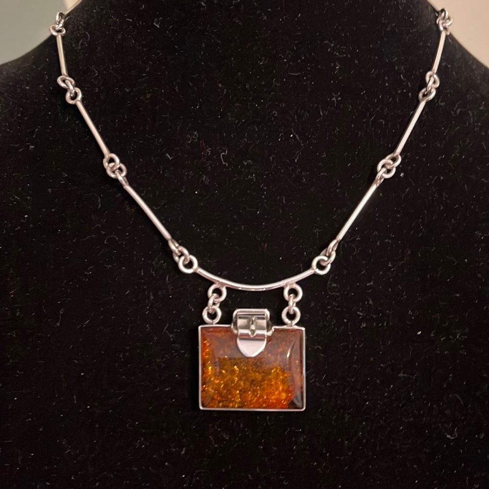 Custom made necklace made out of sterling silver and amber.